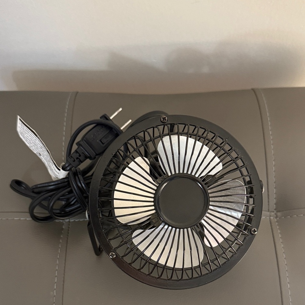 Personal 4 inch metal black electric fan. Portable adjustable tilt